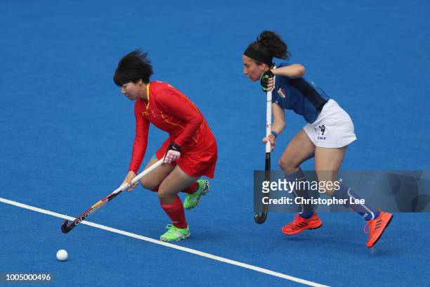 Qiong Wu of China battles with Elisabetta Pacella of Italy during the Pool A game between China and Italy of the FIH Womens Hockey World Cup at Lee...
