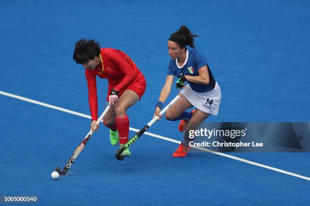 Qiong Wu of China battles with Elisabetta Pacella of Italy during the Pool A game between China and Italy of the FIH Womens Hockey World Cup at Lee...