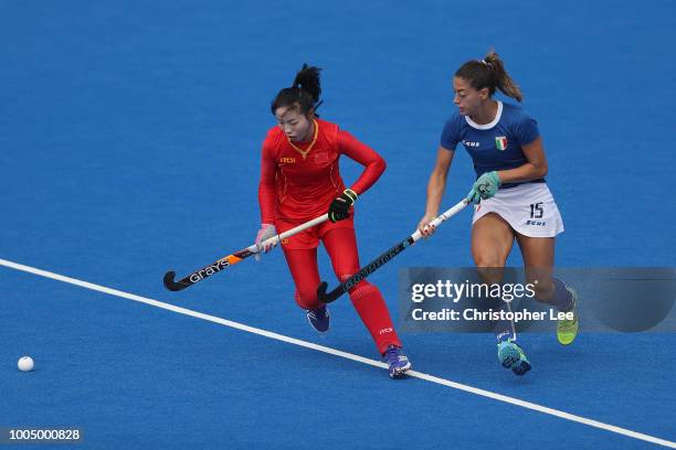 Yang Peng of China battles with Maria Socino of Italy during the Pool A game between China and Italy of the FIH Womens Hockey World Cup at Lee Valley...