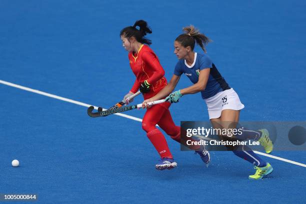 Yang Peng of China battles with Maria Socino of Italy during the Pool A game between China and Italy of the FIH Womens Hockey World Cup at Lee Valley...