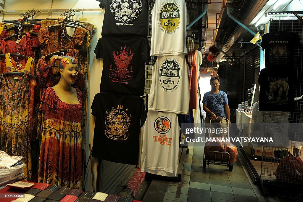 A shopkeeper arranges goods in his shop