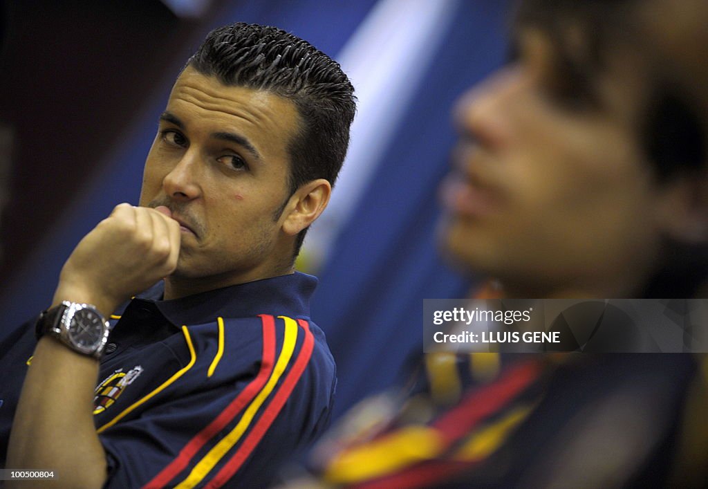 Spain's forward Pedro Rodriguez (L) atte