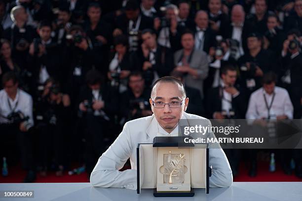 Thai director Apichatpong Weerasethakul poses after receiving the Palm d�Or award for his film "Lung Boonmee Raluek Chat" during the photocall of the...