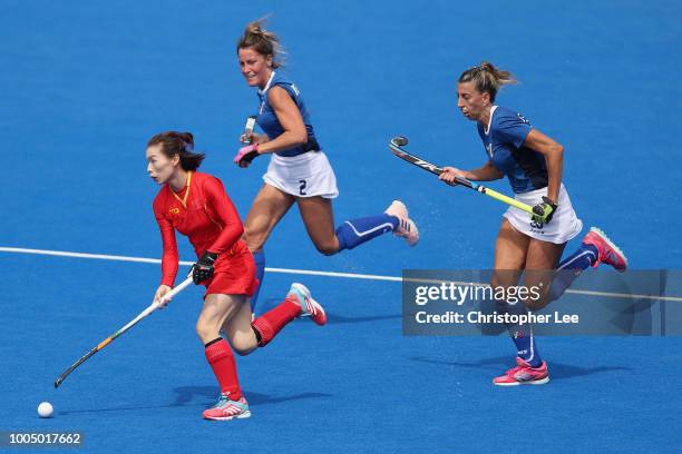 Qiu Guo of China gets away from Celina Traverso of Italy and Ivanna Pessina of Italy during the Pool A game between China and Italy of the FIH Womens...