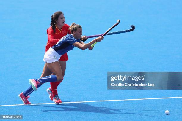 Ivanna Pessina of Italy battles with Bingfeng Gu of China during the Pool A game between China and Italy of the FIH Womens Hockey World Cup at Lee...