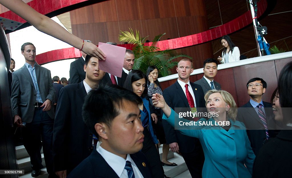 A young Chinese girl reaches out to hand