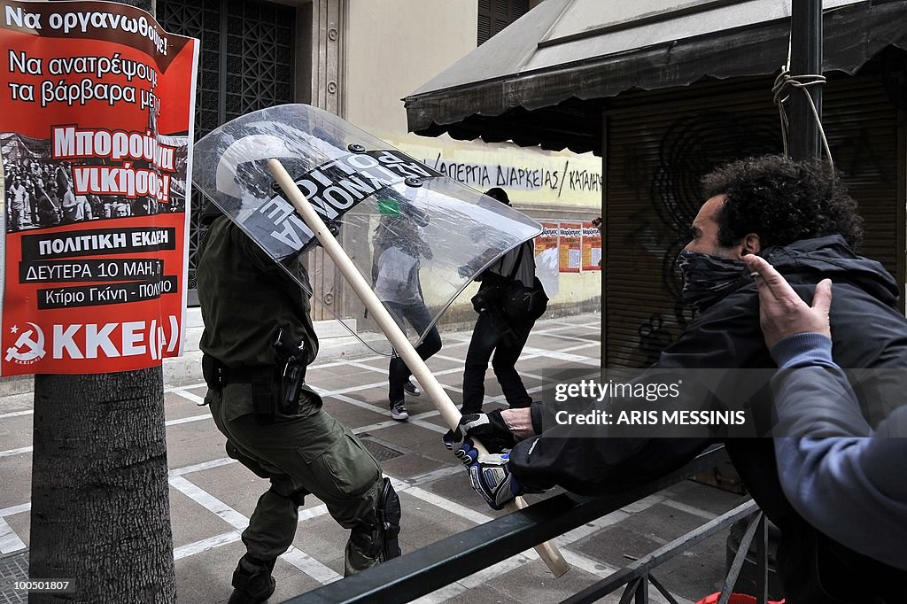 A protestor clashes with police in the c