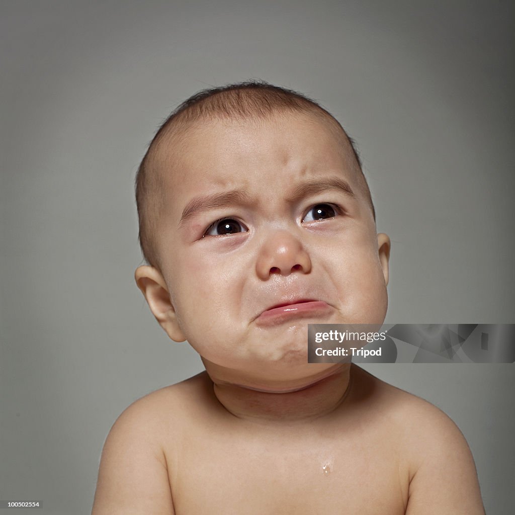 Baby boy (6-9 months) crying, close-up