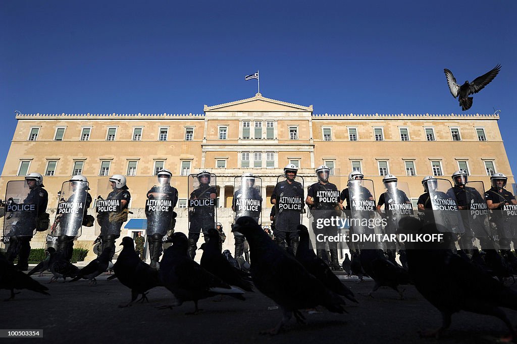 A pigeon flies over riot policemen durin