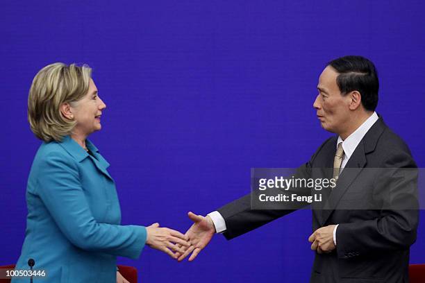 Secretary of State Hillary Clinton shakes hands with China's Vice Premier Wang Qishan after a press conference for the China-U.S. Strategic and...