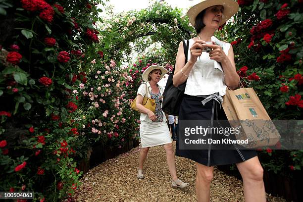People walk through the rose garden at the annual Chelsea flower show on May 25, 2010 in London, England. The Royal Horticultural Society flagship...