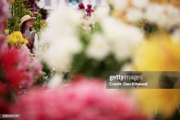 Woman walks through stalls at the annual Chelsea flower show on May 25, 2010 in London, England. The Royal Horticultural Society flagship flower show...