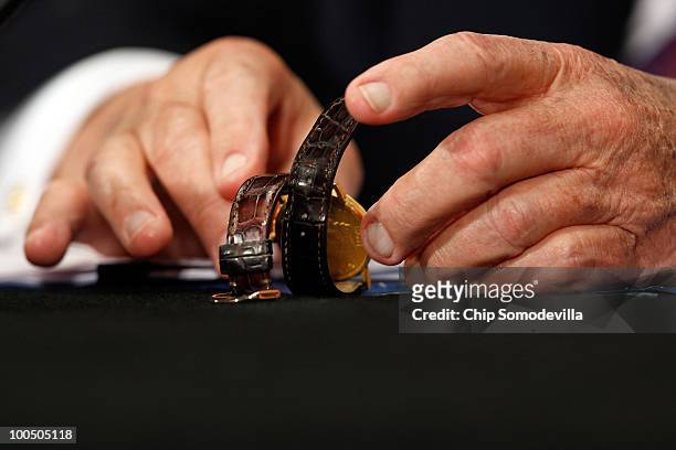 Former secretary of state Henry Kissinger sets up his wrist watch before testifying to the Senate Foreign Relations Committee about the new Strategic...