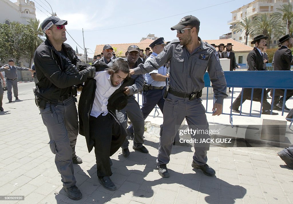 Israeli policemen detain an ultra-Orthod
