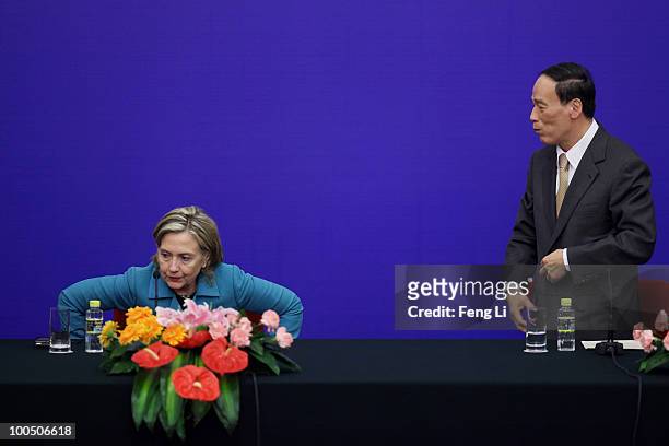 Secretary of State Hillary Clinton and China's Vice Premier Wang Qishan stand up after a press conference for the China-U.S. Strategic and Economic...