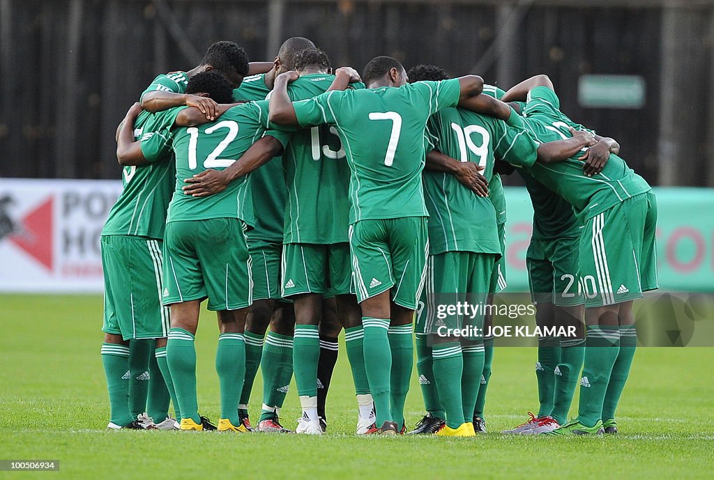 Nigerian Players pray during their frien