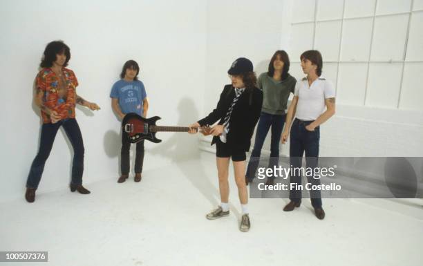 Bon Scott, Malcolm Young, Angus Young, Cliff Williams and Phil Rudd of Australian rock band AC/DC pose in London, England in August 1979.