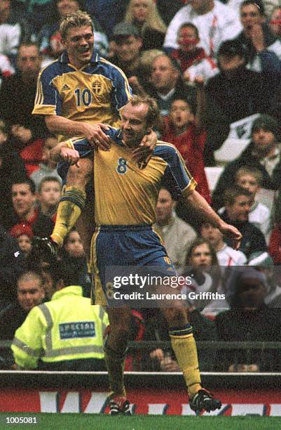 Hakan Mild of Sweden celebrates his goal with Marcus Allback during the England v Sweden International friendly at Old Trafford, Manchester....