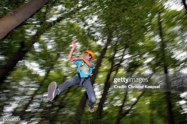 Climber Benny hangs on a rope during a climbing session at the GHW tightrobe climbing garden on May 25, 2010 in Hueckeswagen, Germany.