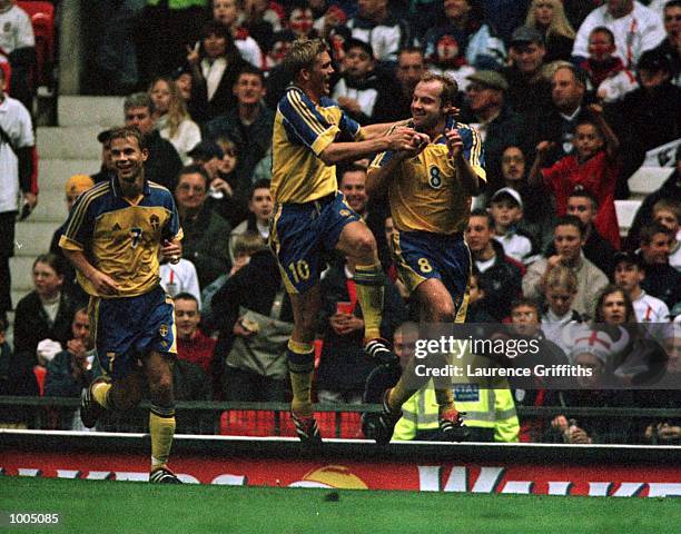 Hakan Mild of Sweden celebrates with Marcus Allback after scoring the equalising goal during the England v Sweden International friendly at Old...