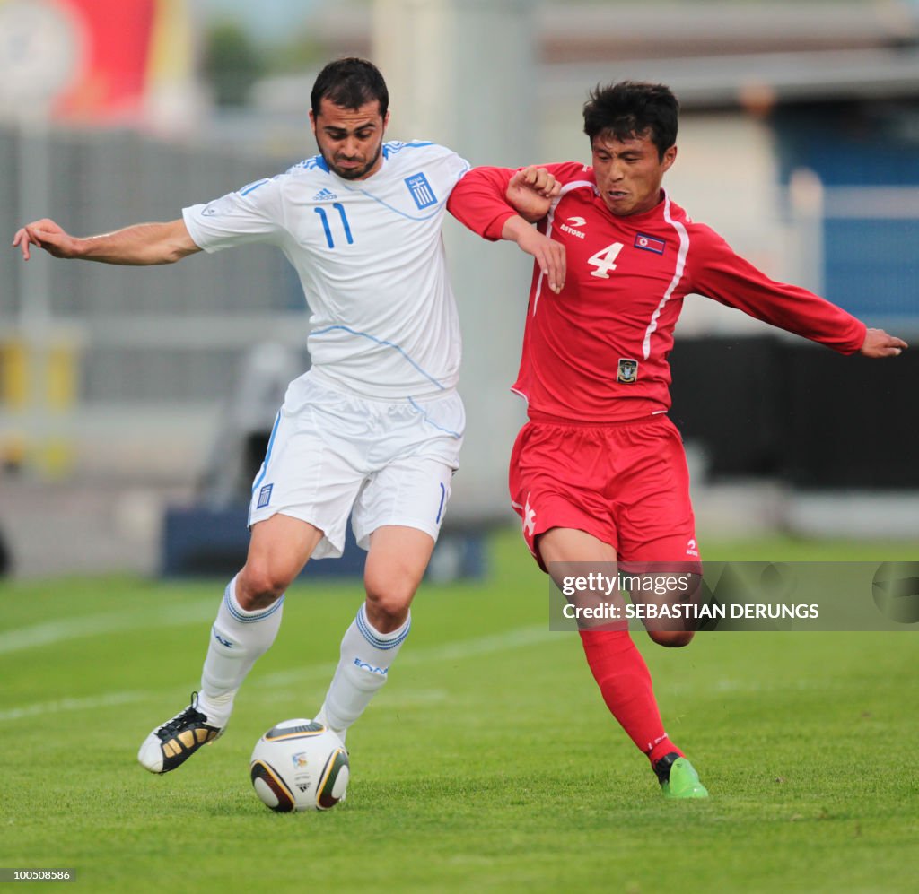Greece's Loukas Vyntra (L) vies for the