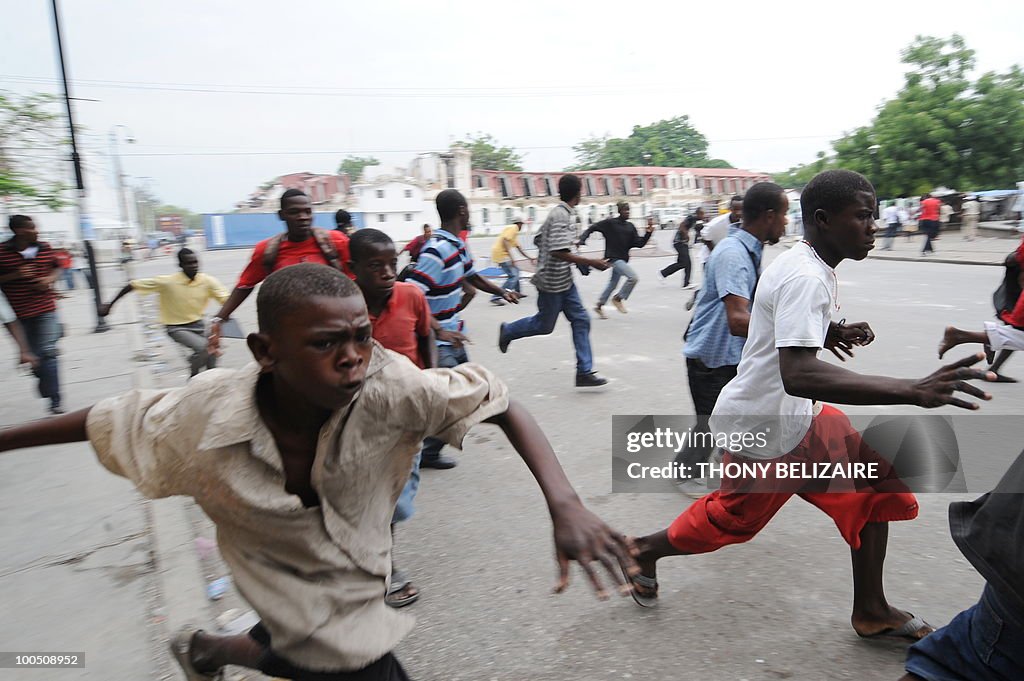 Haitian students run as they demonstrate