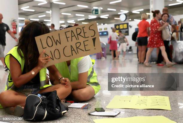 July 2018, Mallorca, Spain: cabin crew of the airline Ryanair demonstrates at Palma de Mallorca airport with signs and demands more money and better...