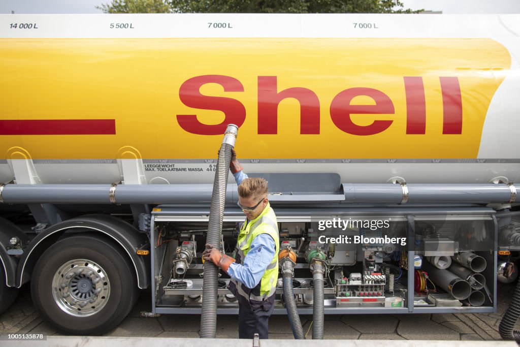 Shell Tea Tanker A worker secures hoses as a Shell tanker truck delivers fuel to a gas ...
