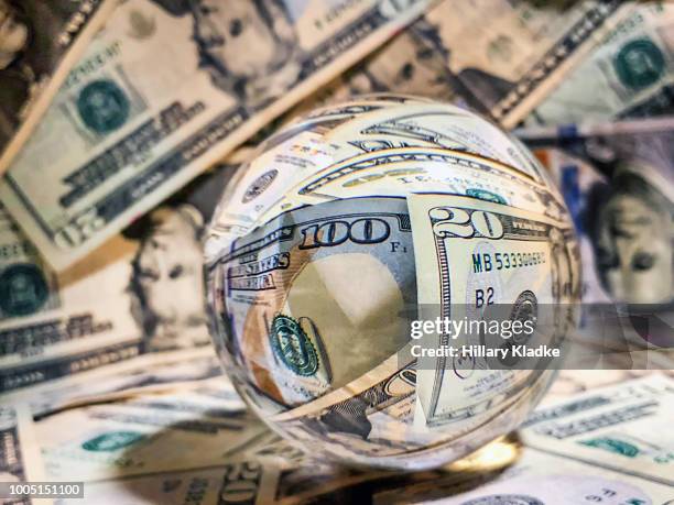 glass ball with reflections of money - fortune teller stock pictures, royalty-free photos & images