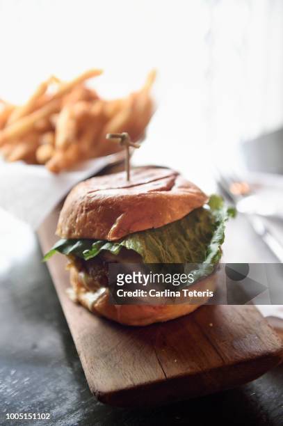 classic burger and fries at a trendy cafe - gastro pub stock pictures, royalty-free photos & images