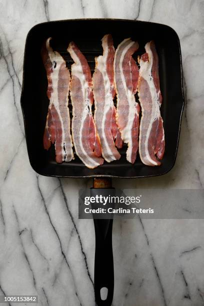 raw bacon rashers on a grill pan - bacon strip stock pictures, royalty-free photos & images