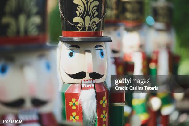 row of christmas nutcracker figurines in sunlight - nutcracker stock pictures, royalty-free photos & images