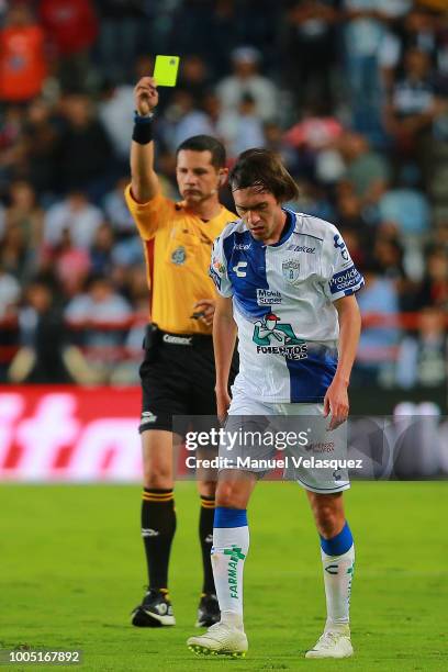 Central referee, Diego Montano, shows the yellow card to Joaquin Martinez of Pachca during the 1st round match between Pachuca and Monterrey as part...