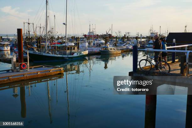 people watching harbor view with fishing boats at steveston fisherman's wharf in richmond bc canada - richmond   british columbia ストックフォトと画像