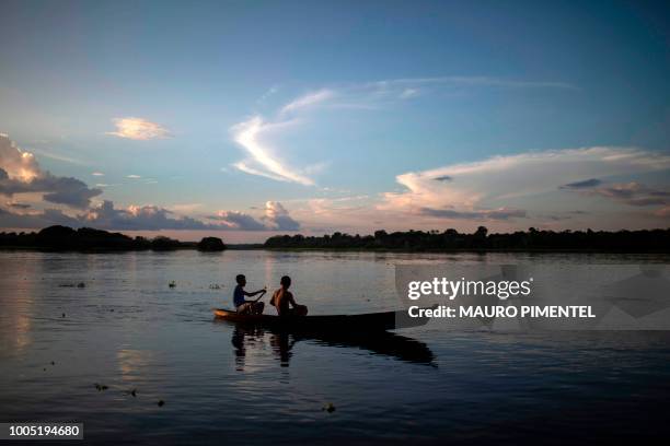 Youngsters of Sao Raimundo do Jaraua village remain on a boat in the Jaragua river in the state of Amazonas, Brazil, on June 27, 2018.