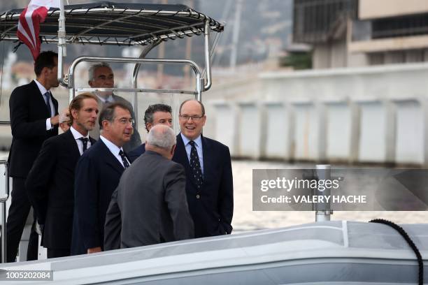 Monaco's Prince Albert shares a light moment with Archbishop of Monaco Bernard Barsi Martin Bouygues , Monaco Minister of State Serge Telle, Andre...