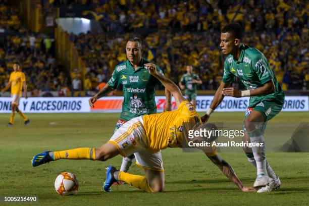 Andre-Pierre Gignac of Tigres fights for the ball with William Tesillo and Luis Montes of Leon during the 1st round match between Tigres UANL and...