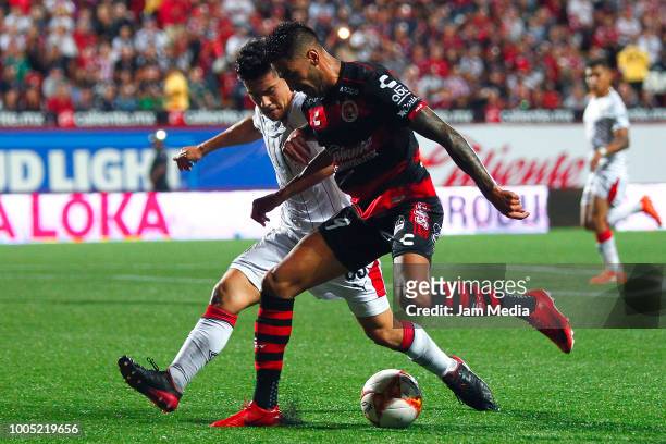 Michael Perez of Chivas fights for the ball with Martin Lucero of Tijuana during the 1st round match between Tijuana and Chivas as part of the Torneo...