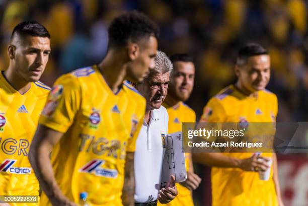 Ricardo Ferretti, coach of Tigres, gets in the field surrounded by some of his players during the 1st round match between Tigres UANL and Leon as...