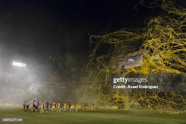 Yellow serpentines are seen over Tigres and Leon players as they get in the Universitario Stadium prior the 1st round match between Tigres UANL and...