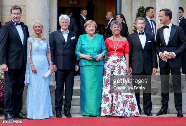 Bavaria's State Premier Markus Soeder poses next to his wife Karin Baumueller, Mayor of Bayreuth Brigitte Merk-Erbe, s husband Thomas Erbe, German...
