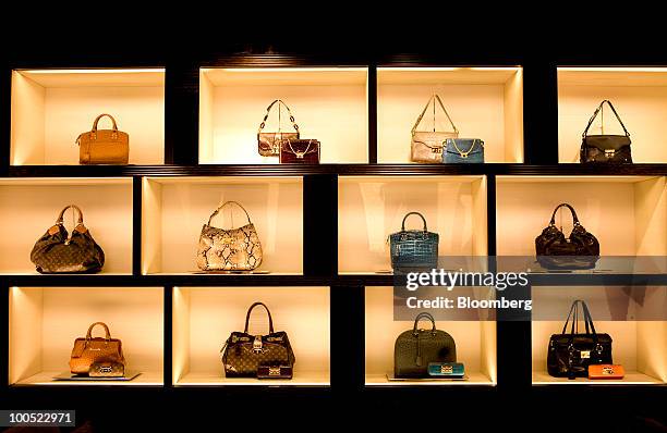 Louis Vuitton branded goods sit on display at the LVMH Moet Hennessy Louis Vuitton SA "maison" store in New Bond Street in London, U.K., on Tuesday,...