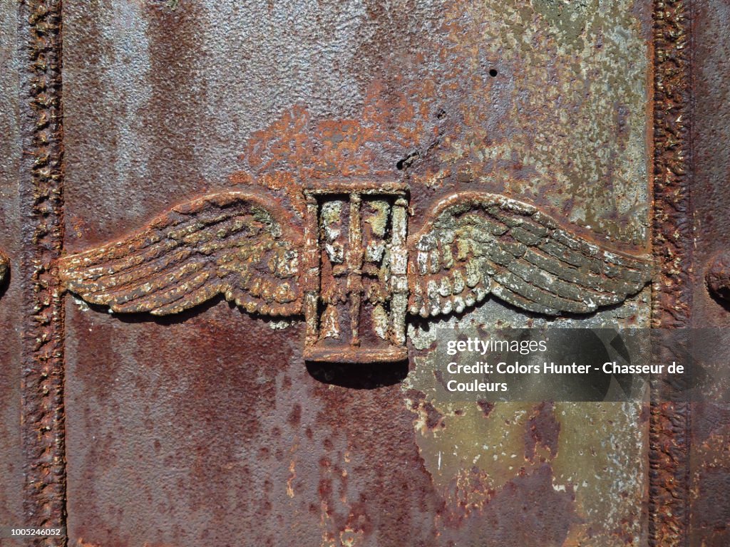 Metallic winged hourglass on a tombstone