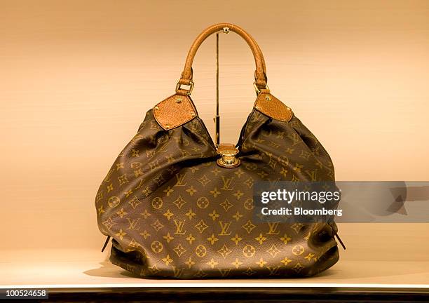 Louis Vuitton branded handbag sits on display at the LVMH Moet Hennessy Louis Vuitton SA "maison" store in New Bond Street in London, U.K., on...