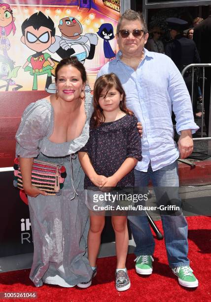 Actors Meredith Salenger, Patton Oswalt and daughter Alice Rigney Oswalt arrive at the Los Angeles premiere of Warner Bros. Animations' 'Teen Titans...