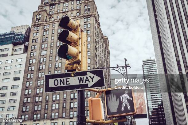 traffic light in midtown manhattan - pedestrian light stock pictures, royalty-free photos & images