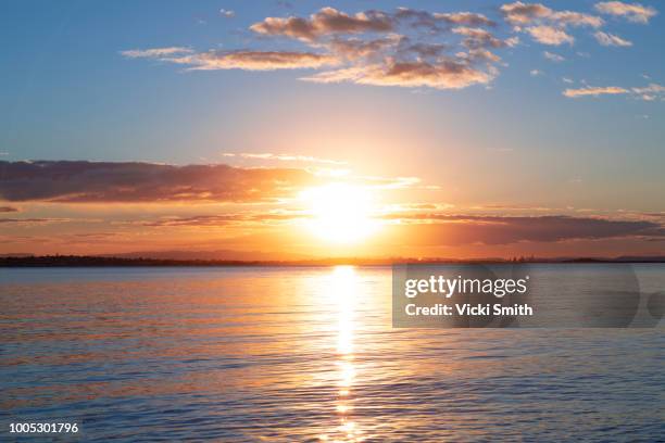 sunrise over the ocean - aurora foto e immagini stock