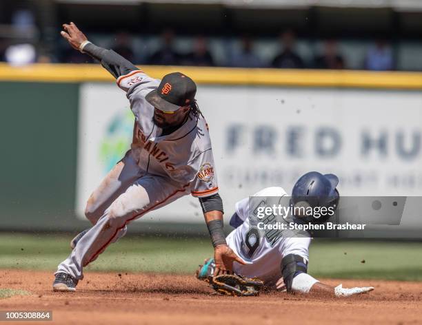 Dee Gordon of the Seattle Mariners steals second base as second baseman Alen Hanson of the San Francisco Giants cannot hold on to a throw by catcher...
