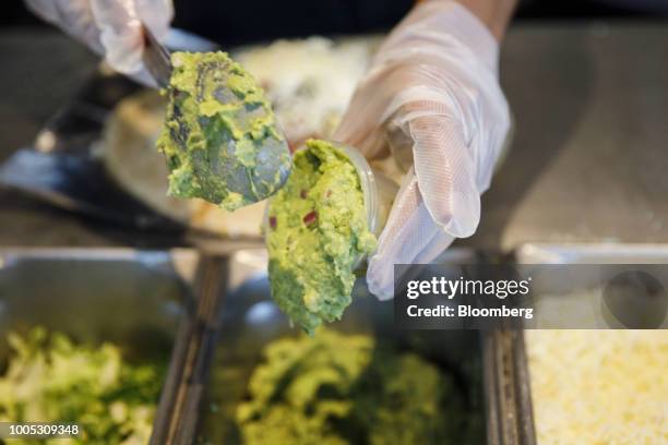 An employee scoops guacamole at a Chipotle Mexican Grill Inc. Restaurant in El Segundo, California, U.S., on Wednesday, July 25, 2018. Chipotle is...