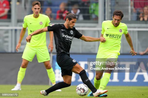 Goncalo Pascienca of Eintracht Frankfurt challenges Patrik Schoenfeld of SV Wehen Wiesbaden during the Pre Season Friendly Match between SV Wehen...